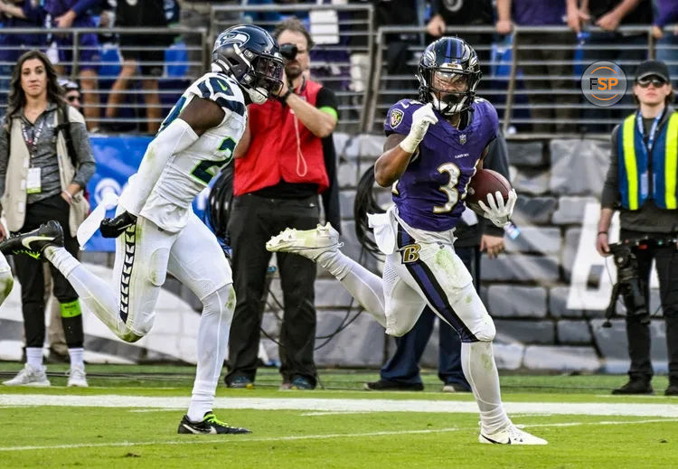 BALTIMORE, MD - NOVEMBER 05: Baltimore Ravens running back Keaton Mitchell (34) runs for a touchdown against Seattle Seahawks cornerback Riq Woolen (27) during the Seattle Seahawks game versus the Baltimore Ravens on November 5, 2023 at M&T Bank Stadium in Baltimore, MD. (Photo by Mark Goldman/Icon Sportswire)
