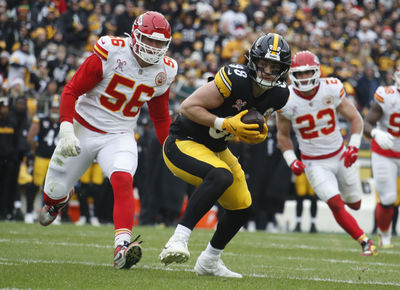 Dec 25, 2024; Pittsburgh, Pennsylvania, USA;  Pittsburgh Steelers tight end Pat Freiermuth (88) runs after a catch against Kansas City Chiefs defensive end George Karlaftis (56) during the second quarter at Acrisure Stadium. Mandatory Credit: Charles LeClaire-Imagn Images