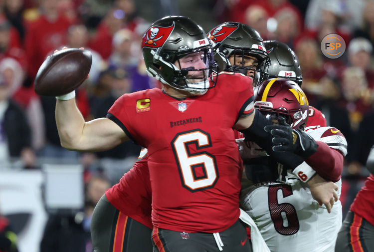 Jan 12, 2025; Tampa, Florida, USA; Tampa Bay Buccaneers quarterback Baker Mayfield (6) throws against Washington Commanders linebacker Dante Fowler Jr. (6) during the second quarter of a NFC wild card playoff at Raymond James Stadium. Credit: Kim Klement Neitzel-Imagn Images