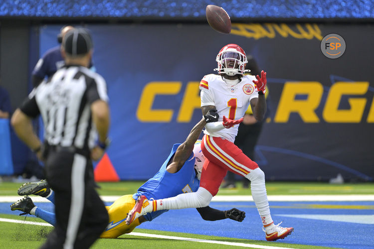Sep 29, 2024; Inglewood, California, USA;  Kansas City Chiefs wide receiver Xavier Worthy (1) is defended by Los Angeles Chargers cornerback Kristian Fulton (7) as he hangs on to a touchdown pass in the first half at SoFi Stadium. Credit: Jayne Kamin-Oncea-Imagn Images