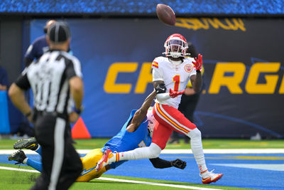 Sep 29, 2024; Inglewood, California, USA;  Kansas City Chiefs wide receiver Xavier Worthy (1) is defended by Los Angeles Chargers cornerback Kristian Fulton (7) as he hangs on to a touchdown pass in the first half at SoFi Stadium. Mandatory Credit: Jayne Kamin-Oncea-Imagn Images