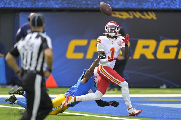 Sep 29, 2024; Inglewood, California, USA;  Kansas City Chiefs wide receiver Xavier Worthy (1) is defended by Los Angeles Chargers cornerback Kristian Fulton (7) as he hangs on to a touchdown pass in the first half at SoFi Stadium. Mandatory Credit: Jayne Kamin-Oncea-Imagn Images