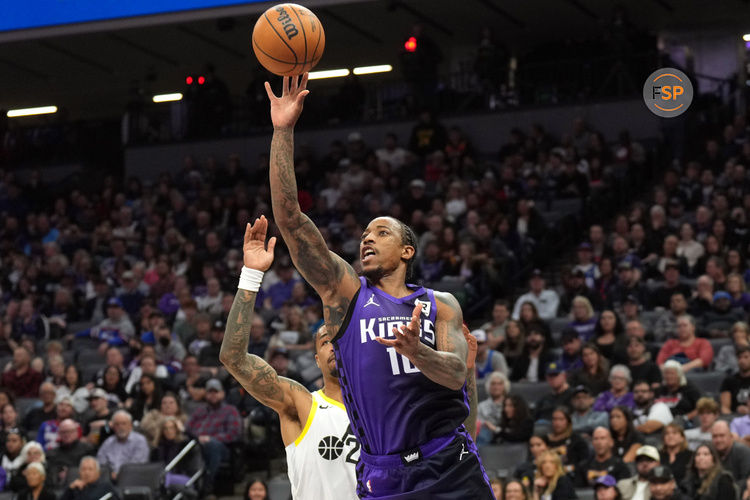 Dec 8, 2024; Sacramento, California, USA; Sacramento Kings forward DeMar DeRozan (front) shoots against Utah Jazz forward John Collins (back) during the second quarter at Golden 1 Center. Credit: Darren Yamashita-Imagn Images