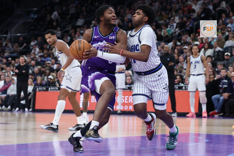 Dec 20, 2025; Salt Lake City, Utah, USA; Utah Jazz guard Isaiah Collier (8) drives to the basket against Orlando Magic guard Jase Richardson (11) during the second half at Delta Center. Credit: Rob Gray-Imagn Images