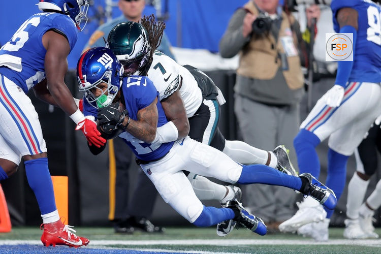 Oct 9, 2025; East Rutherford, New Jersey, USA; New York Giants wide receiver Wan'Dale Robinson (17) dives for a touchdown against Philadelphia Eagles cornerback Kelee Ringo (7) during the first quarter at MetLife Stadium. Credit: Brad Penner-Imagn Images