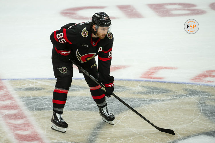 Jan 16, 2025; Ottawa, Ontario, CAN; Ottawa Senators defenseman Jake Sanderson (85) gets in position for a faceoff in the third period against the Washington Capitals at the Canadian Tire Centre. Credit: Marc DesRosiers-Imagn Images