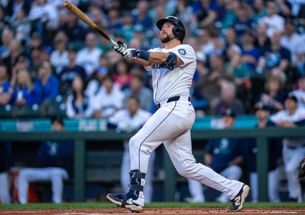 May 27, 2025; Seattle, Washington, USA;  Seattle Mariners catcher Cal Raleigh (29) hits a solo home run during the first inning against the Washington Nationals at T-Mobile Park. Mandatory Credit: Stephen Brashear-Imagn Images