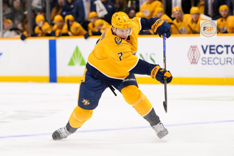 Jan 21, 2025; Nashville, Tennessee, USA;  Nashville Predators defenseman Luke Schenn (2) takes a shot on goal against the San Jose Sharks during the first period at Bridgestone Arena. Credit: Steve Roberts-Imagn Images