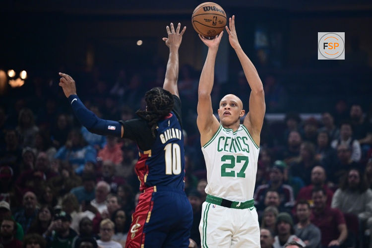 Nov 30, 2025; Cleveland, Ohio, USA; Boston Celtics guard Jordan Walsh (27) shoots a three point shot over Cleveland Cavaliers guard Darius Garland (10) during the first half at Rocket Arena. Credit: David Dermer-Imagn Images
