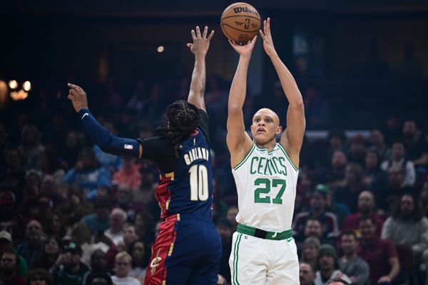 Nov 30, 2025; Cleveland, Ohio, USA; Boston Celtics guard Jordan Walsh (27) shoots a three point shot over Cleveland Cavaliers guard Darius Garland (10) during the first half at Rocket Arena. Mandatory Credit: David Dermer-Imagn Images