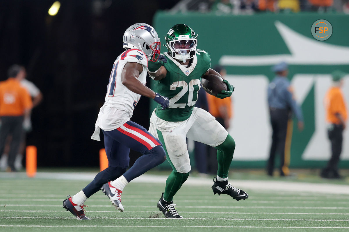 Sep 19, 2024; East Rutherford, New Jersey, USA; New York Jets running back Breece Hall (20) runs with the ball against New England Patriots cornerback Jonathan Jones (31) during the second quarter at MetLife Stadium. Credit: Brad Penner-Imagn Images