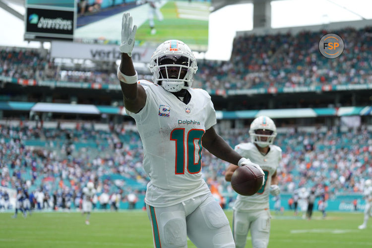 MIAMI GARDENS, FL - OCTOBER 08: Miami Dolphins wide receiver Tyreek Hill (10) looks for someone specific to give the touchdown ball to following his long touchdown catch and run in the second half during the game between the New York Giants and the Miami Dolphins on Sunday, October 8, 2023 at Hard Rock Stadium, Miami Gardens, Fla. (Photo by Peter Joneleit/Icon Sportswire)