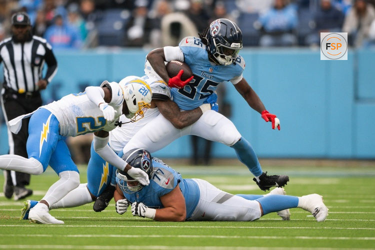 Nov 2, 2025; Nashville, Tennessee, USA;  Los Angeles Chargers safety Derwin James Jr. (3) tackles Tennessee Titans tight end Chigoziem Okonkwo (85) during the first half at Nissan Stadium. Credit: Steve Roberts-Imagn Images