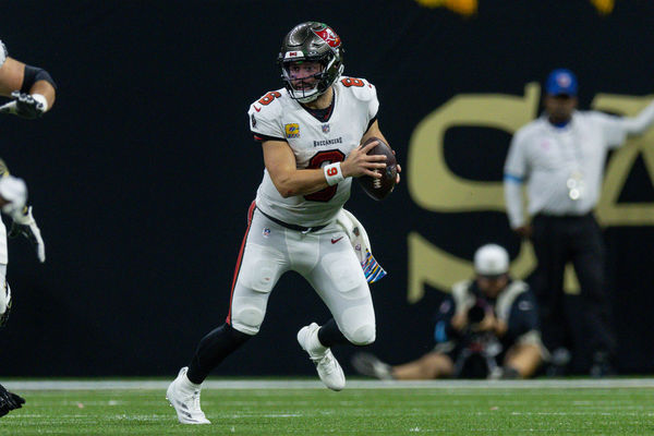 Oct 13, 2024; New Orleans, Louisiana, USA;  Tampa Bay Buccaneers quarterback Baker Mayfield (6) scrambles out the pocket against the New Orleans Saints during the second half at Caesars Superdome. Mandatory Credit: Stephen Lew-Imagn Images