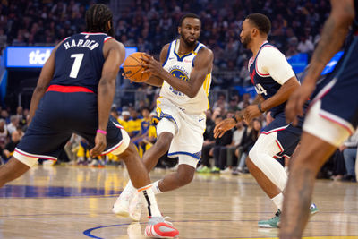 Oct 27, 2024; San Francisco, California, USA; Golden State Warriors forward Andrew Wiggins (22) drives to the basket between Los Angeles Clippers guards James Harden (1) and Norman Powell (24) during the first quarter at Chase Center. Mandatory Credit: D. Ross Cameron-Imagn Images