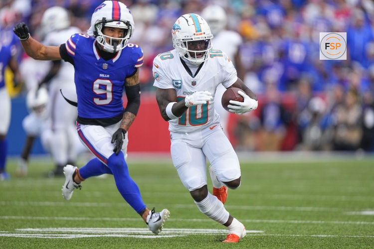 Nov 3, 2024; Orchard Park, New York, USA; Miami Dolphins wide receiver Tyreek Hill (10) runs with the ball against Buffalo Bills safety Taylor Rapp (9) during the second half at Highmark Stadium. Credit: Gregory Fisher-Imagn Images