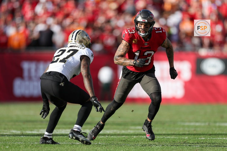 Jan 5, 2025; Tampa, Florida, USA; Tampa Bay Buccaneers wide receiver Mike Evans (13) runs a route guarded by New Orleans Saints cornerback Shemar Jean-Charles (27) in the fourth quarter at Raymond James Stadium. Credit: Nathan Ray Seebeck-Imagn Images