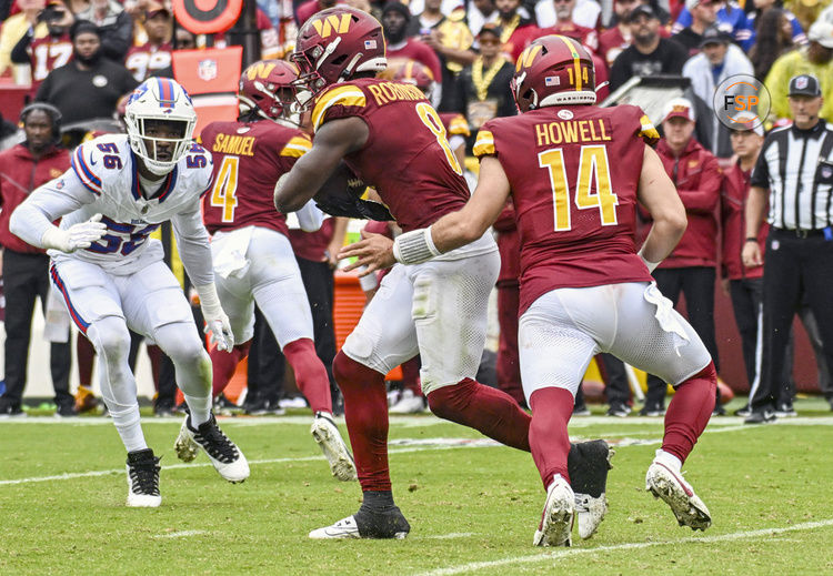 LANDOVER, MD - SEPTEMBER 24: Washington Commanders running back Brian Robinson Jr. (8) takes a handoff from quarterback Sam Howell (14) during the NFL game between the Buffalo Bills and the Washington Commanders on September 24, 2023 at Fed Ex Field in Landover, MD.  (Photo by Mark Goldman/Icon Sportswire)