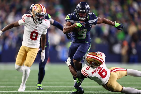 Jan 17, 2026; Seattle, WA, USA; Seattle Seahawks running back Kenneth Walker III (9) carries the ball as San Francisco 49ers safety Malik Mustapha (6) defends during the second half in an NFC Divisional Round game at Lumen Field. Mandatory Credit: Kevin Ng-Imagn Images