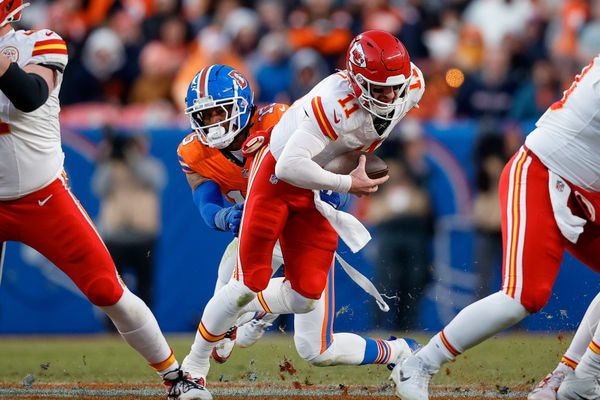 Jan 5, 2025; Denver, Colorado, USA; Kansas City Chiefs quarterback Carson Wentz (11) is sacked by Denver Broncos linebacker Nik Bonitto (15) in the third quarter at Empower Field at Mile High. Mandatory Credit: Isaiah J. Downing-Imagn Images