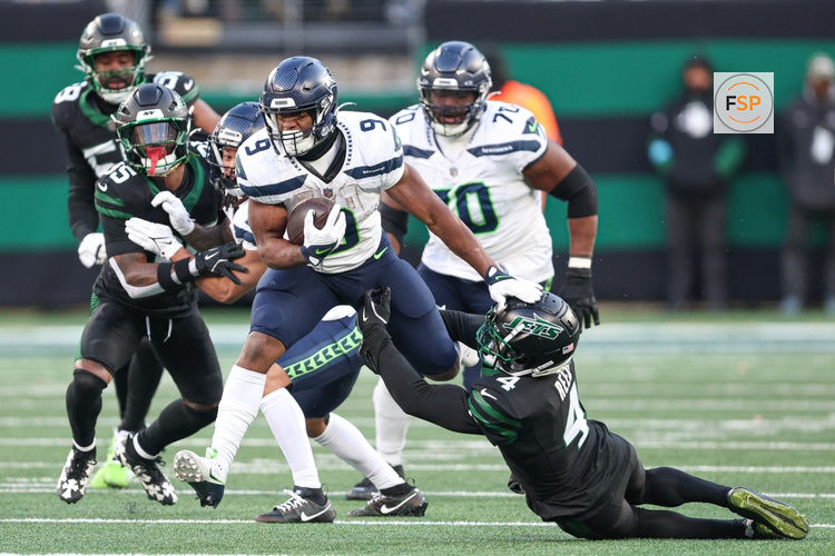 Dec 1, 2024; East Rutherford, New Jersey, USA; Seattle Seahawks running back Kenneth Walker III (9) is tackled by New York Jets cornerback D.J. Reed (4) during the second half at MetLife Stadium. Credit: Vincent Carchietta-Imagn Images