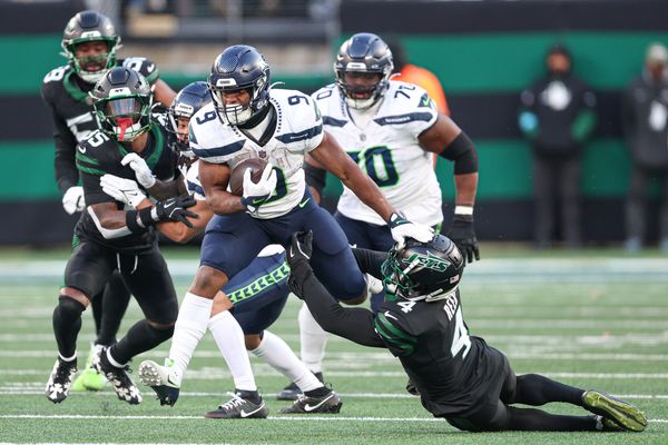 Dec 1, 2024; East Rutherford, New Jersey, USA; Seattle Seahawks running back Kenneth Walker III (9) is tackled by New York Jets cornerback D.J. Reed (4) during the second half at MetLife Stadium. Mandatory Credit: Vincent Carchietta-Imagn Images