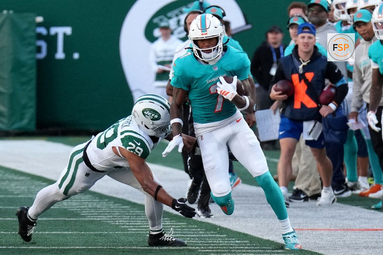 Oct 25, 2026; East Rutherford, New Jersey, USA;  Miami Dolphins wide receiver Caleb Douglas (7) stays in bounds and avoids New York Jets safety Minkah Fitzpatrick (29) for a touchdown reception during the second half at MetLife Stadium.  Credit: Robert Deutsch-Imagn Images