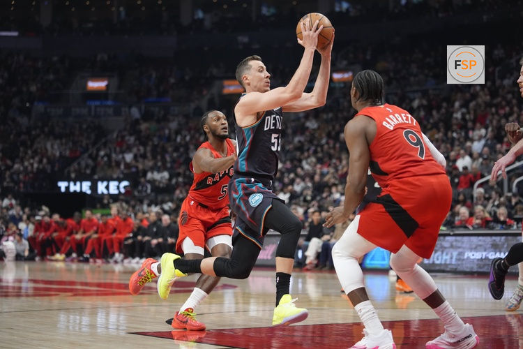 Mar 15, 2026; Toronto, Ontario, CAN; Detroit Pistons guard Duncan Robinson (55) drives against Toronto Raptors forward RJ Barrett (9) and guard Immanuel Quickley (5) during the first half at Scotiabank Arena. Credit: John E. Sokolowski-Imagn Images