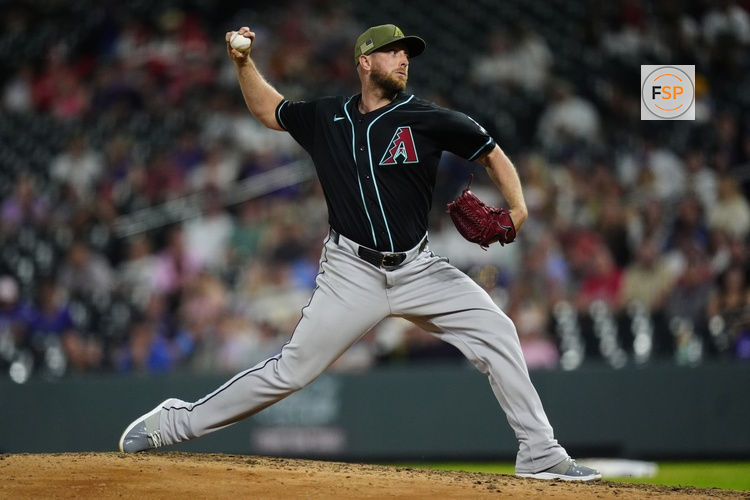 May 15, 2026; Denver, Colorado, USA; Arizona Diamondbacks starting pitcher Merrill Kelly (29) delivers a pitch in the ninth inning against the Colorado Rockies at Coors Field. Credit: Ron Chenoy-Imagn Images
