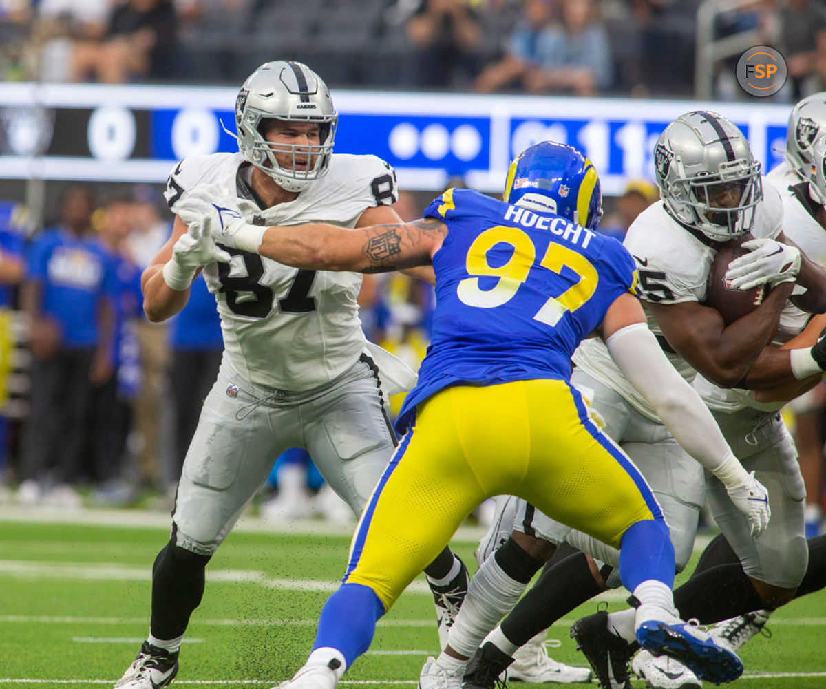 INGLEWOOD, CA - AUGUST 19: Las Vegas Raiders tight end Michael Mayer (87) gets held back by Los Angeles Rams outside linebacker Michael Hoecht (97) in the first half of a preseason NFL football game between the Las Vegas Raiders and Los Angeles Rams at SoFi Stadium in Inglewood, California. (Photo by Tony Ding/Icon Sportswire)