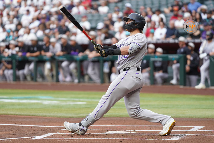 May 17, 2025; Phoenix, Arizona, USA;  Colorado Rockies catcher Hunter Goodman (15) hits a home run against the Arizona Diamondbacks in the first inning at Chase Field. Credit: Jacob Reiner-Imagn Images