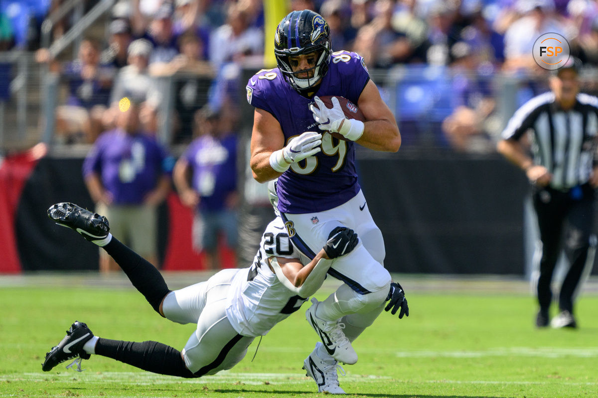 Sep 15, 2024; Baltimore, Maryland, USA; Baltimore Ravens tight end Mark Andrews (89) runs with the ball as Las Vegas Raiders safety Isaiah Pola-Mao (20) attempts to make a tackle during the first half at M&T Bank Stadium. Credit: Reggie Hildred-Imagn Images