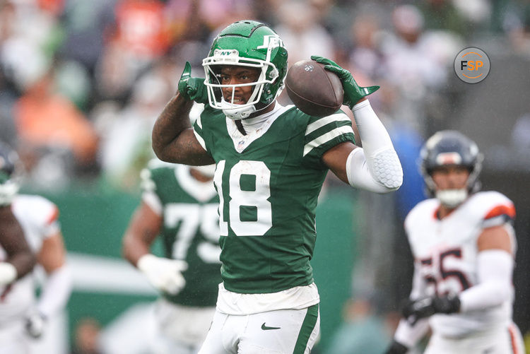 Sep 29, 2024; East Rutherford, New Jersey, USA; New York Jets wide receiver Mike Williams (18) celebrates a first down reception during the second half against the Denver Broncos at MetLife Stadium. Credit: Vincent Carchietta-Imagn Images