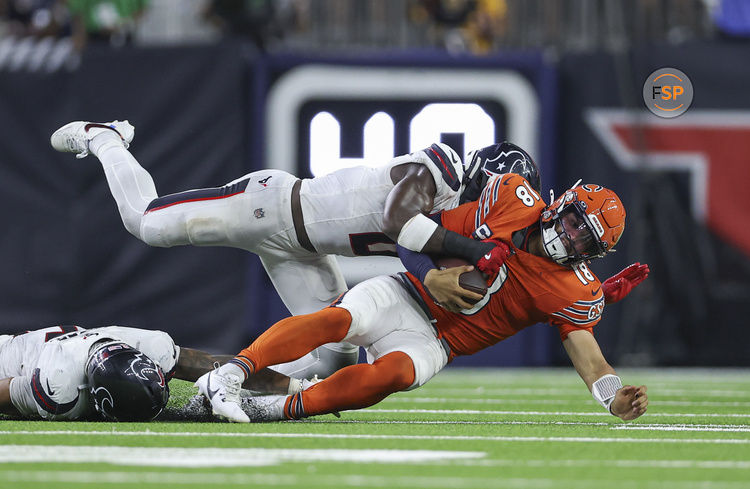 Sep 15, 2024; Houston, Texas, USA; Houston Texans linebacker Azeez Al-Shaair (0) tackles Chicago Bears quarterback Caleb Williams (18) during the fourth quarter at NRG Stadium. Credit: Troy Taormina-Imagn Images