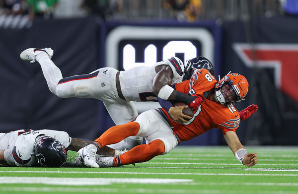 Sep 15, 2024; Houston, Texas, USA; Houston Texans linebacker Azeez Al-Shaair (0) tackles Chicago Bears quarterback Caleb Williams (18) during the fourth quarter at NRG Stadium. Mandatory Credit: Troy Taormina-Imagn Images