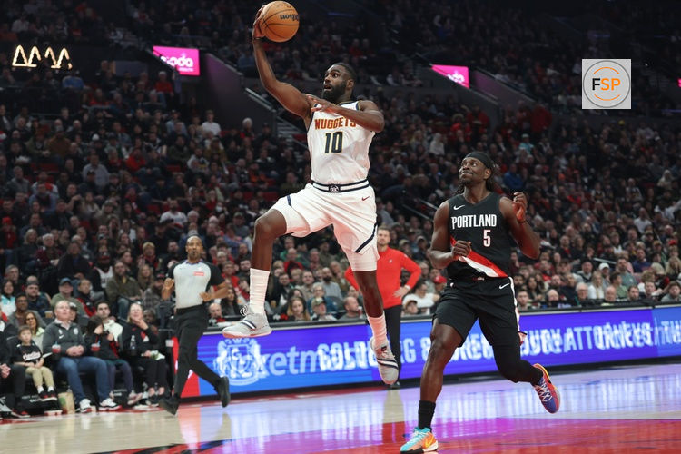 Feb 20, 2026; Portland, Oregon, USA;  Denver Nuggets guard/forward Tim Hardaway Jr. (10) shoots over Portland Trail Blazers guard Jrue Holiday (5) during first half at Moda Center. Credit: Jaime Valdez-Imagn Images