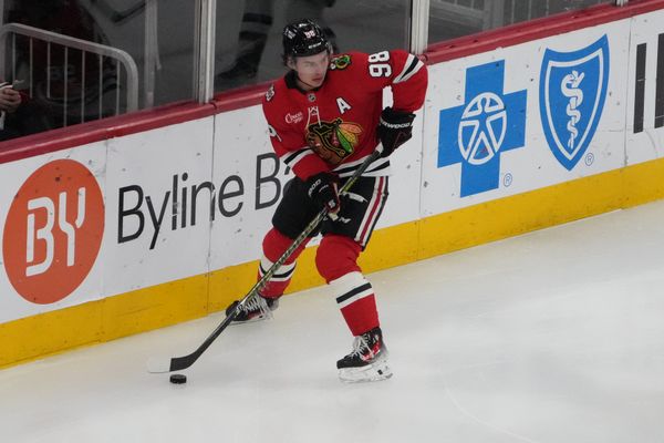 Apr 15, 2026; Chicago, Illinois, USA; Chicago Blackhawks center Connor Bedard (98) grabs the puck against the San Jose Sharks during the first period at United Center. Mandatory Credit: David Banks-Imagn Images
