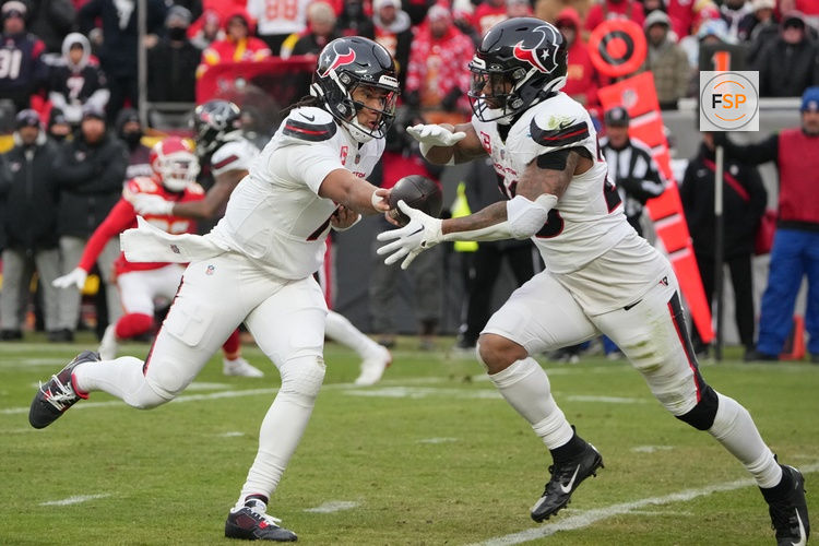 Jan 18, 2025; Kansas City, Missouri, USA; Houston Texans quarterback C.J. Stroud (7) hands off the ball to running back Joe Mixon (28) against the Kansas City Chiefs during the second quarter of a 2025 AFC divisional round game at GEHA Field at Arrowhead Stadium. Credit: Denny Medley-Imagn Images