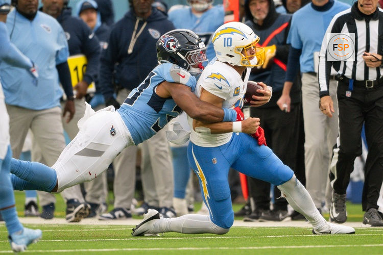 Nov 2, 2025; Nashville, Tennessee, USA;  Tennessee Titans linebacker Cedric Gray (33) tackles Los Angeles Chargers quarterback Justin Herbert (10) for a loss during the second half at Nissan Stadium. Credit: Steve Roberts-Imagn Images