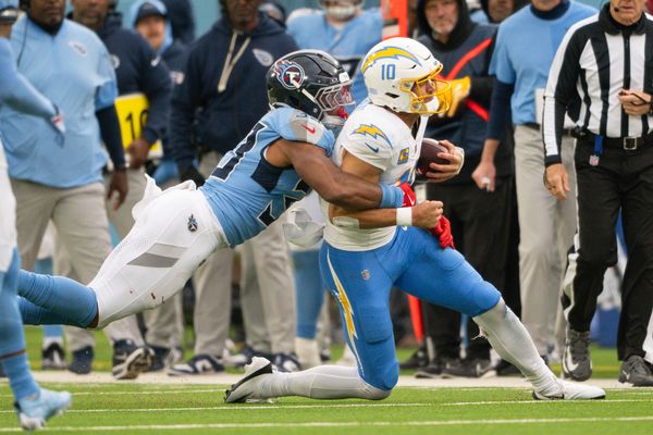 Nov 2, 2025; Nashville, Tennessee, USA;  Tennessee Titans linebacker Cedric Gray (33) tackles Los Angeles Chargers quarterback Justin Herbert (10) for a loss during the second half at Nissan Stadium. Mandatory Credit: Steve Roberts-Imagn Images