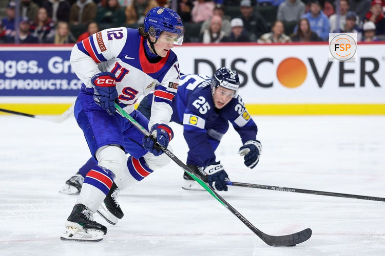 Jan 2, 2026; St. Paul, Minnesota, UNITED STATES; United States forward Will Zellers (12) skates with the puck as Finland defenseman Lasse Boelius (25) defends during the third period in the quarterfinals of the 2026 IIHF World Junior Championship at Grand Casino Arena. Credit: Matt Krohn-Imagn Images