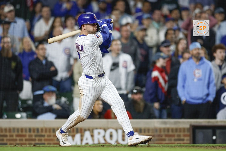 May 13, 2025; Chicago, Illinois, USA; Chicago Cubs second baseman Nico Hoerner (2) hits an RBI-single against the Miami Marlins during the ninth inning at Wrigley Field. Credit: Kamil Krzaczynski-Imagn Images