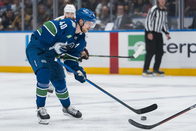 Mar 15, 2025; Vancouver, British Columbia, CAN; Vancouver Canucks forward Elias Pettersson (40) handles the puck against the Chicago Blackhawks in the third period at Rogers Arena. Mandatory Credit: Bob Frid-Imagn Images