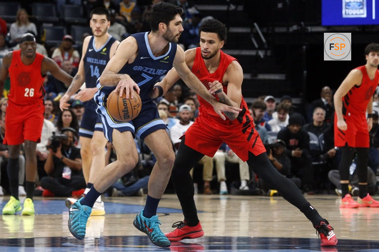 Dec 7, 2025; Memphis, Tennessee, USA; Memphis Grizzlies forward Santi Aldama (7) dribbles as Portland Trail Blazers forward Toumani Camara (33) defends during the second quarter at FedExForum. Credit: Petre Thomas-Imagn Images
