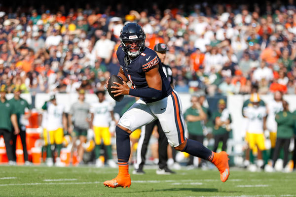CHICAGO, IL - SEPTEMBER 10: Chicago Bears quarterback Justin Fields (1) rolls out to throw a pass in the first half during a regular season game between the Green Bay Packers and the Chicago Bears on September, 10, 2023, at Soldier Field in Chicago, IL. (Photo by Brandon Sloter/Icon Sportswire)