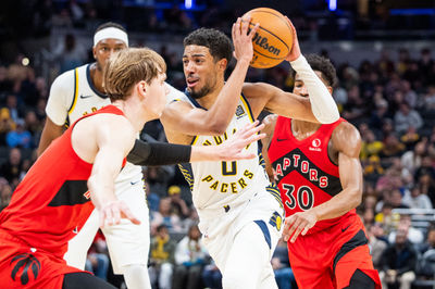 Feb 26, 2025; Indianapolis, Indiana, USA; Indiana Pacers guard Tyrese Haliburton (0) dribbles the ball while Toronto Raptors guard Gradey Dick (1) defends in the second half at Gainbridge Fieldhouse. Mandatory Credit: Trevor Ruszkowski-Imagn Images