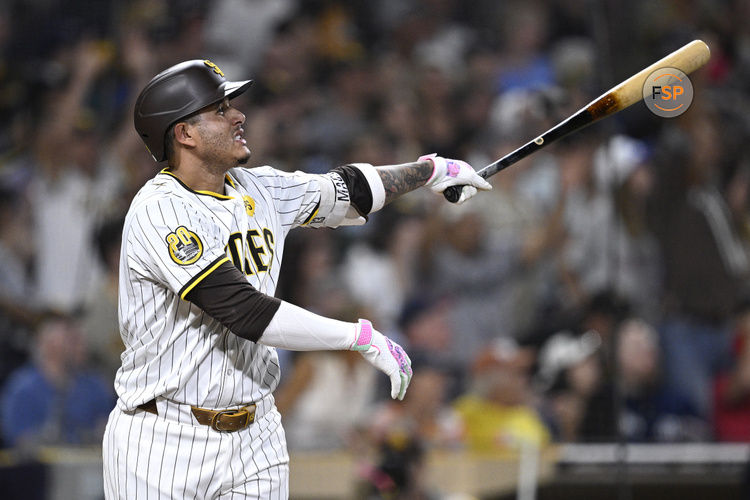 Aug 20, 2024; San Diego, California, USA; San Diego Padres third baseman Manny Machado (13) hits a two-run home run against the Minnesota Twins during the seventh inning at Petco Park. Credit: Orlando Ramirez-USA TODAY Sports