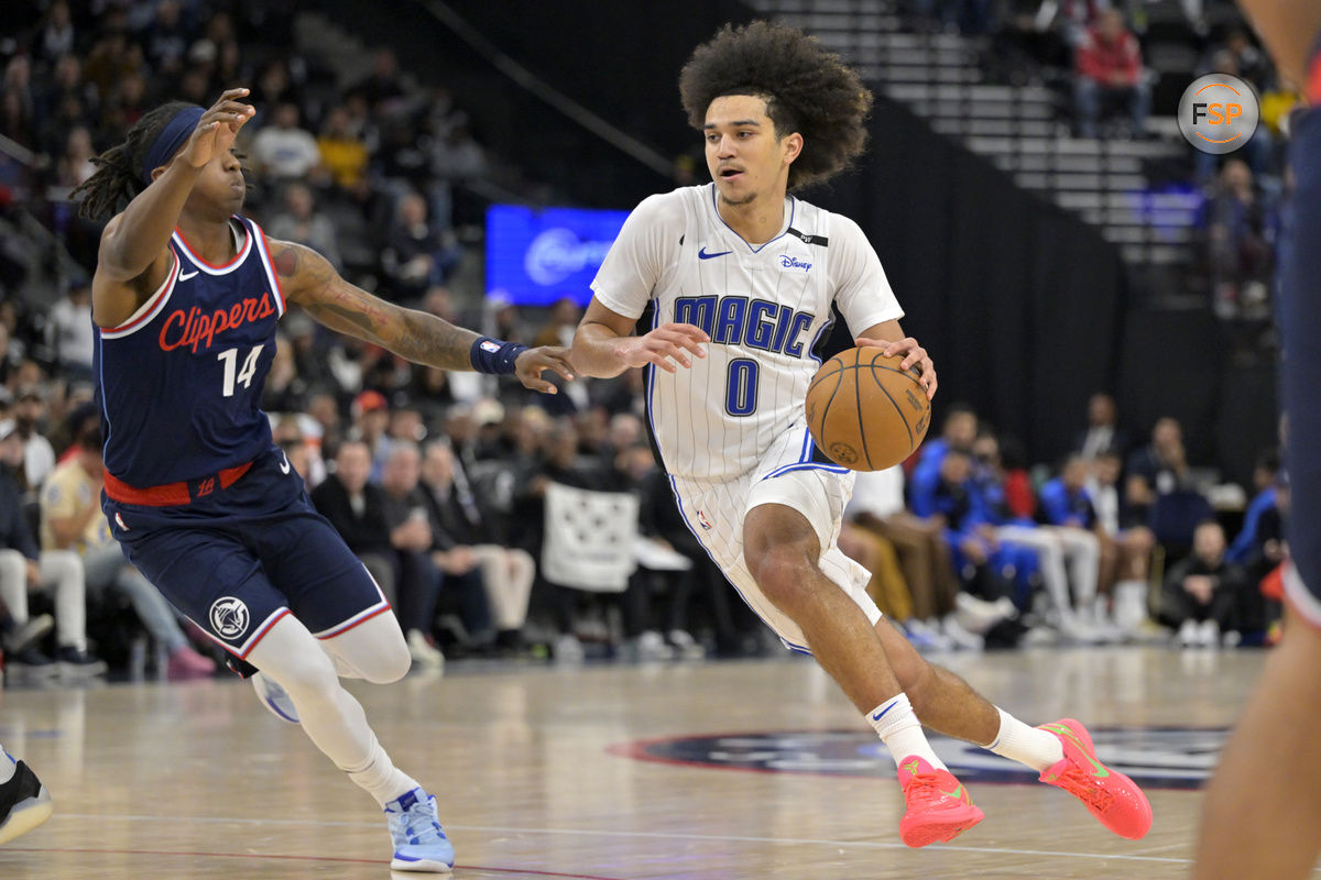 Nov 20, 2024; Inglewood, California, USA;  Los Angeles Clippers guard Terance Mann (14) defends Orlando Magic guard Anthony Black (0) in the second half at Intuit Dome. Credit: Jayne Kamin-Oncea-Imagn Images