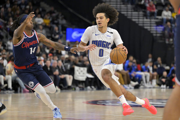 Nov 20, 2024; Inglewood, California, USA;  Los Angeles Clippers guard Terance Mann (14) defends Orlando Magic guard Anthony Black (0) in the second half at Intuit Dome. Mandatory Credit: Jayne Kamin-Oncea-Imagn Images