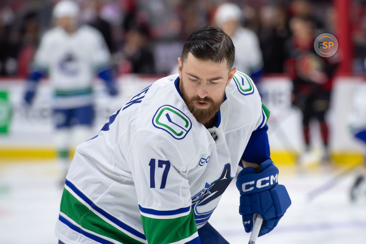 Nov 23, 2024; Ottawa, Ontario, CAN; Vancouver Canucks defenseman Filip Hronek (17) skates with the puck during warmup prior to game against the Ottawa Senators at the Canadian Tire Centre. Credit: Marc DesRosiers-Imagn Images